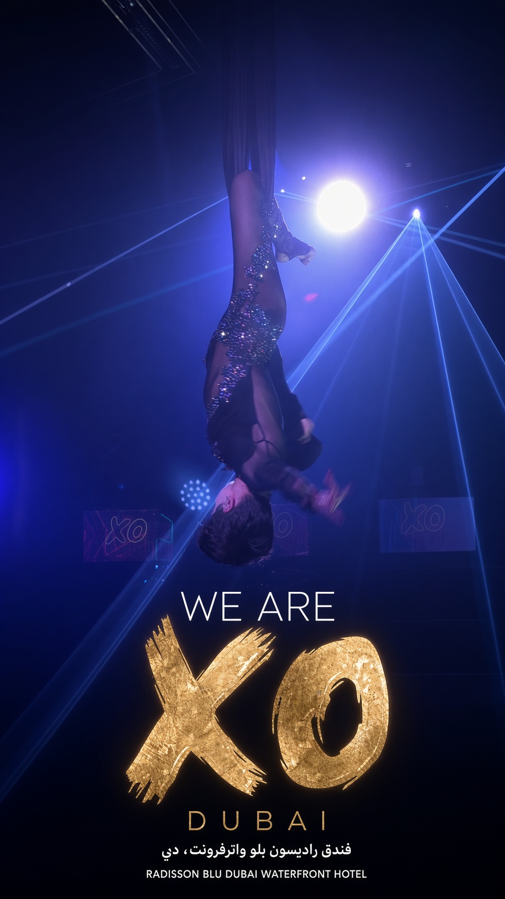 XO Dubai aerial performer under blue lasers